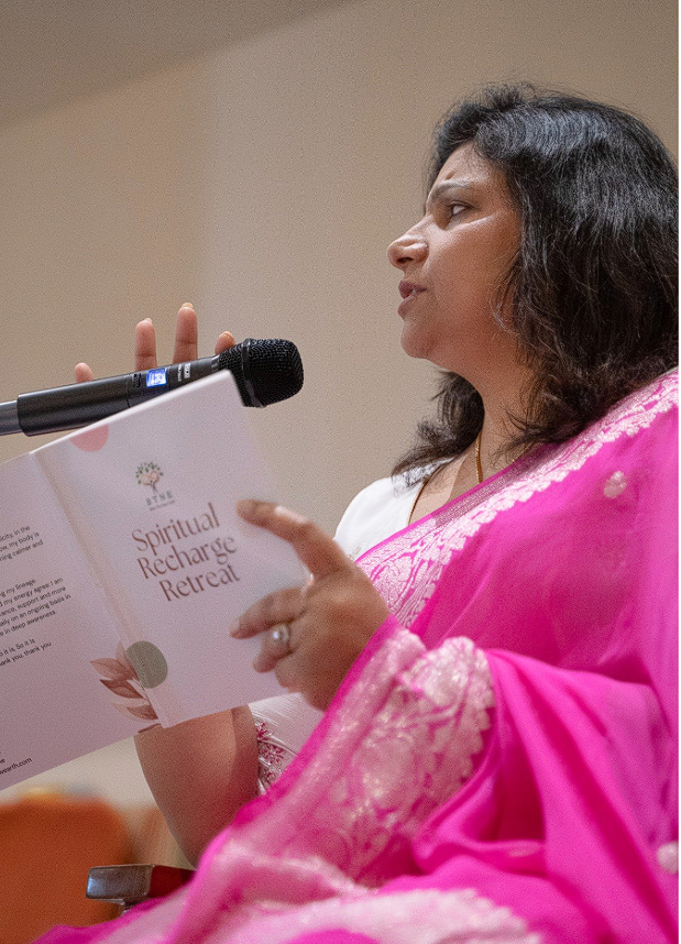 Dr. Monika reading the Spiritual Recharge Retreat book