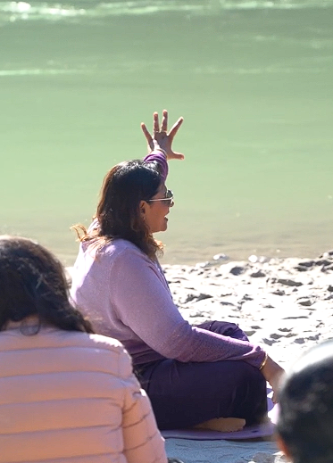 Dr. Monika in meditation by the river — BTNE retreat