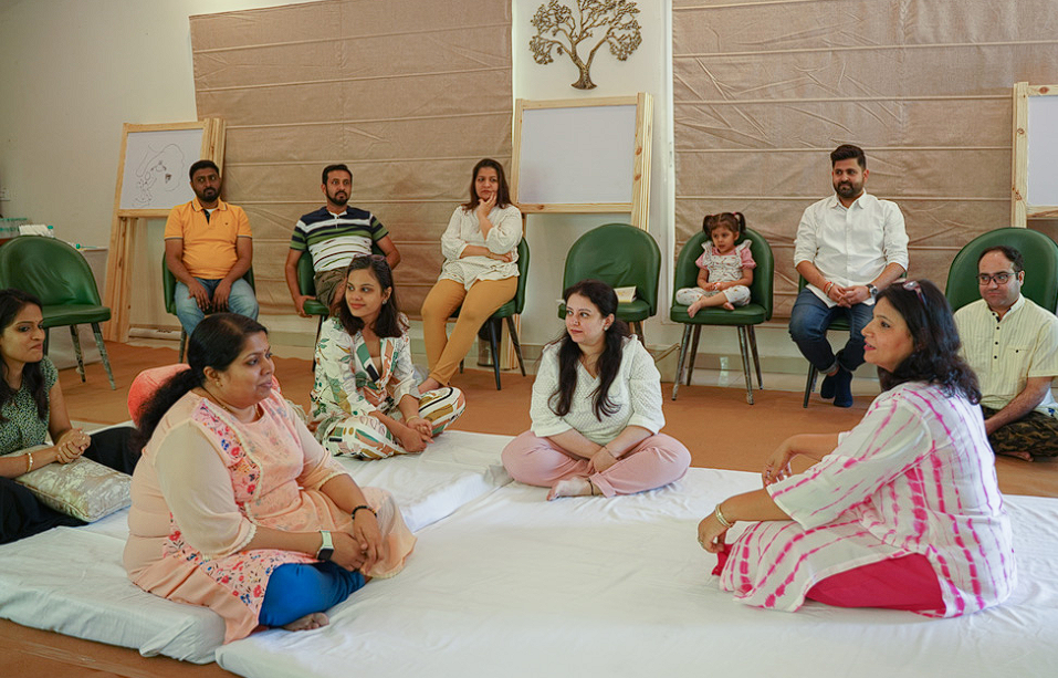 Sharing circle seated on the floor in conversation