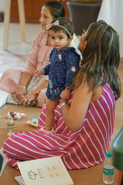 Mother holding her baby during a family circle moment