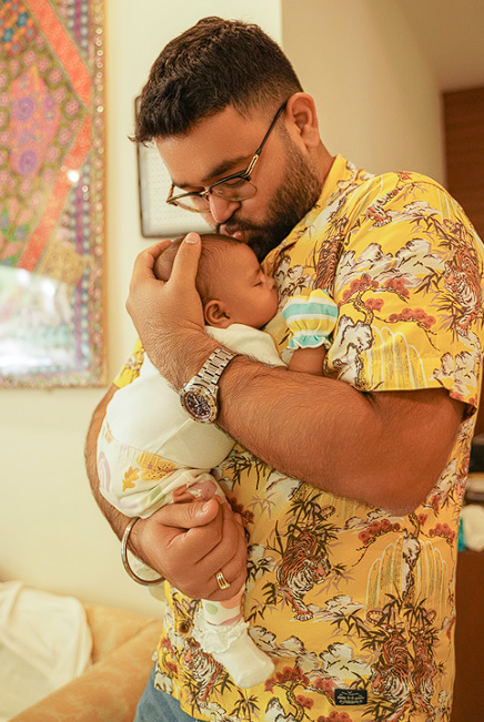 Father kissing his newborn baby in a tender moment