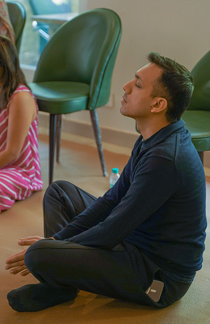 Participant sitting in stillness during a meditation session