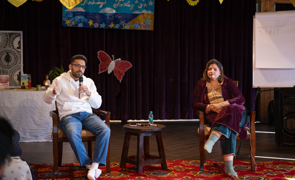 Father sharing his journey on stage with Dr. Monika