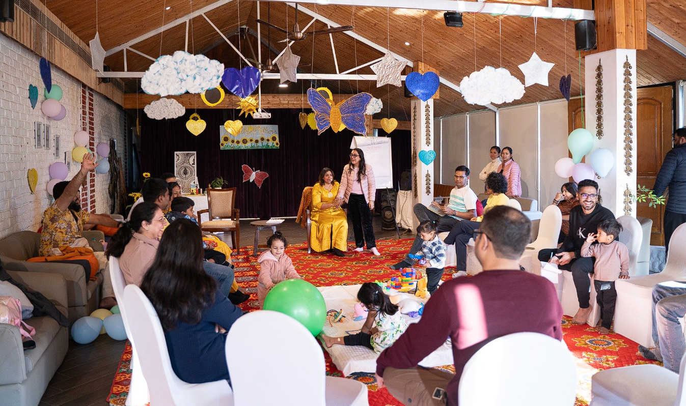 Decorated retreat hall with participants and families