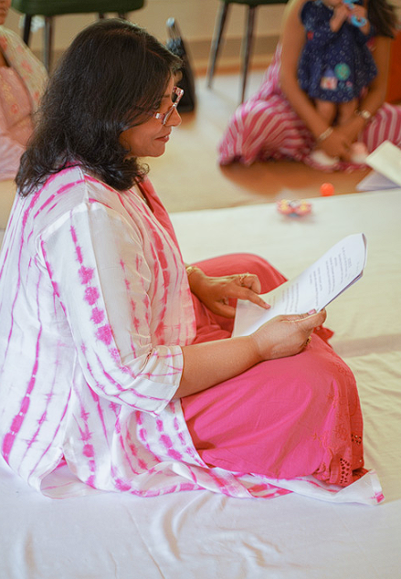 Dr. Monika reading affirmations in a sharing session